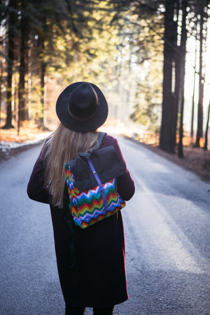 Lonely Woman with bag Walking to the Sunset at Forest
