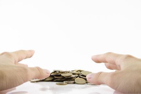 Increase your savings-Hand holding coins against white background