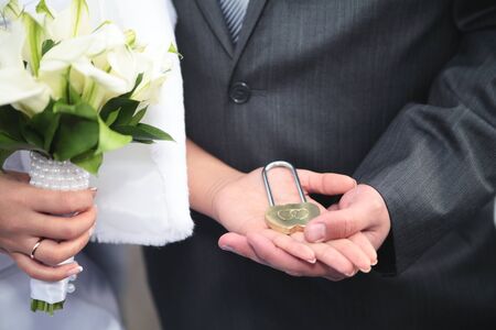 the lock in hands of newlywedsの写真素材
