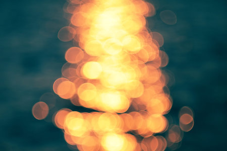Golden sunlights on blue water background 