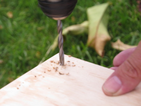 drilling a hole in a piece of woodの写真素材