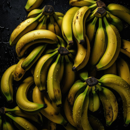 A bunch of ripe bananas on a black background. top view.の素材