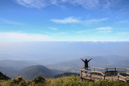 young woman enjoy the view on mountain peak