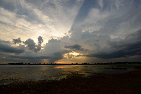 Beautiful cloud at the reservoir, grey clouds and rain with reflectionの写真素材