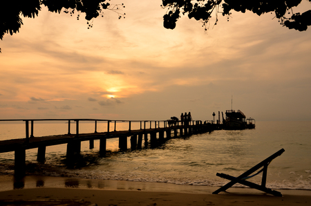 Silhouette of chair and bridge on the beach,sunrise backgroundの写真素材