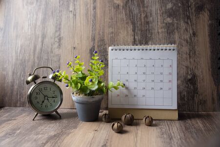 Desktop Calendar 2019 and vintage clock place on wooden office desk.Calender for Planner timetable,agenda appointment,organization,management on table.Calendar Background Concept.の写真素材