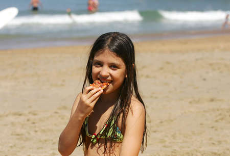 girl eating pizzaの写真素材