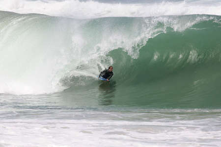 bodyboarder in the tube on a powerful french waveの写真素材