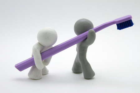 Plasticine characters and toothbrush. Isolated on white backgroundの写真素材