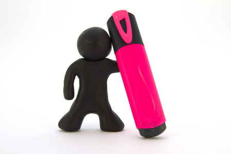 Black  plasticine character and pink marker. Stationery. Isolated on white backgroundの写真素材