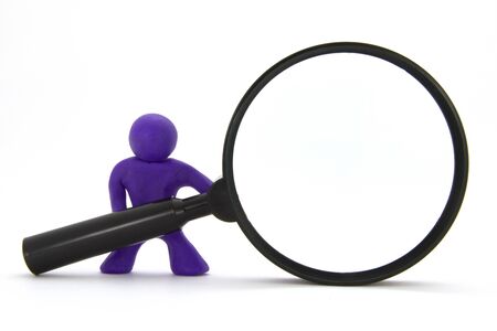 Purple plasticine character and magnifying glass. Isolated on white backgroundの写真素材