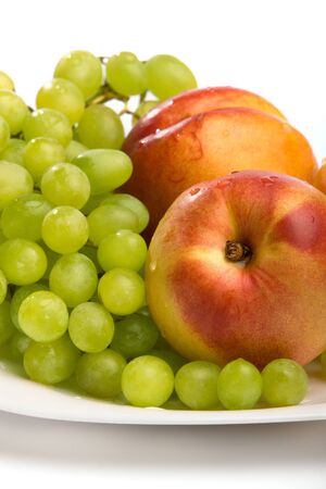 Grapes and peaches on a white backgroundの写真素材