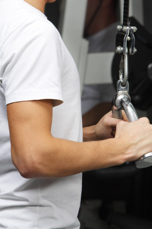 Closeup foto of exercising on training simulator in fitness club