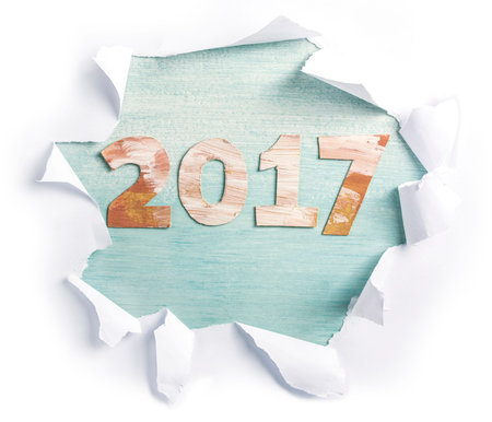 Photo of numbers forming '2017', cut out of paper with golden and white paint strokes, shot from...