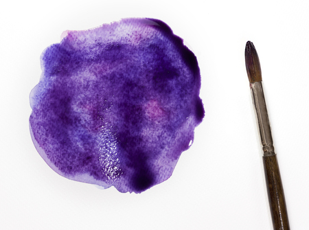 A photo of a freshly painted purple blob with a brush, on white background. Abstract artistic texture with a place for textの写真素材