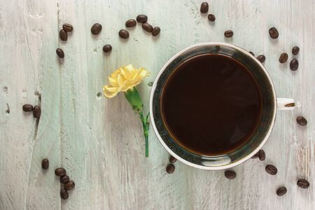 Cup of coffee with grains and flowerの写真素材
