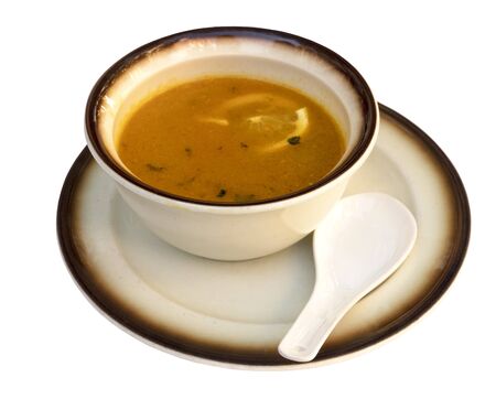 Bowl of chicken soup with lemon, isolated on whiteの写真素材