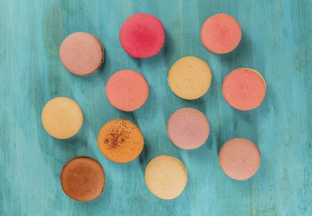 Various macarons on vibrant blue texture with copyspaceの写真素材