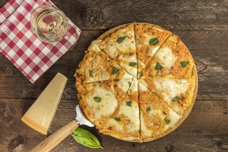 Homemade Margherita pizza with cheese and white wineの写真素材