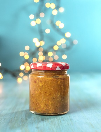 Jar of fruit butter on blurred festive backgroundの写真素材