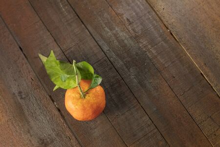 Tangerine on rustic wooden texture with copyspaceの写真素材