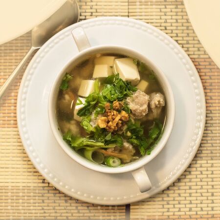 Thai soup with meatballs, vegetables, tofu, and soy noodlesの写真素材