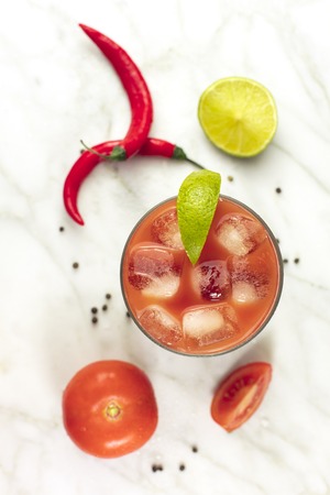 Bloody Mary cocktail, shot from above on white marbleの写真素材