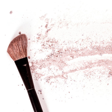 Makeup brush on white background, with traces of powderの写真素材