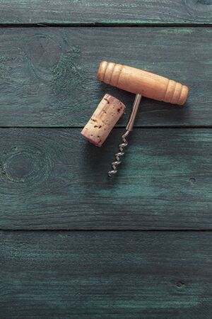 Photo of wine corkscrew and cork on dark backgroundの写真素材