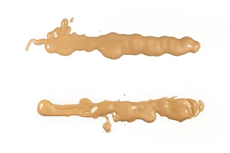 Splashes of makeup base on white background, with copyspaceの写真素材