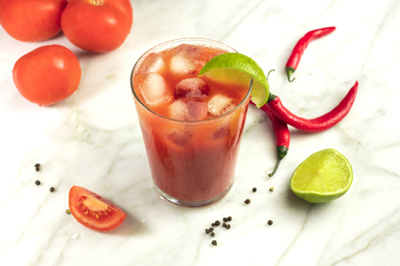Bloody Mary cocktail with lime, tomatoes and chilisの写真素材