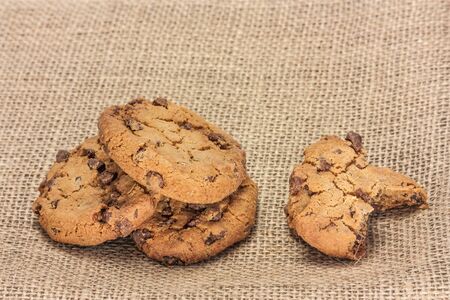 Chocolate chips cookie on burlap texture, with copyspaceの写真素材