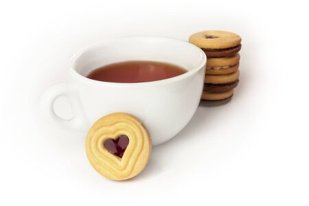 Cup of tea and cookie with heart-shaped fillingの写真素材
