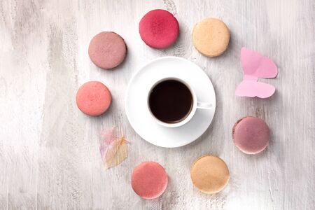 Cup of coffee with macarons and paper butterflyの写真素材