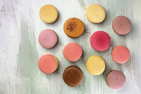 Macarons on pale whitewashed board with copyspaceの写真素材