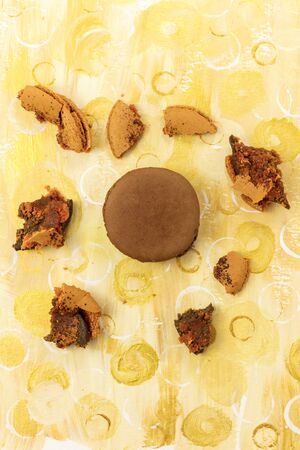 Photo of vibrant macarons with crumbs and copyspaceの写真素材