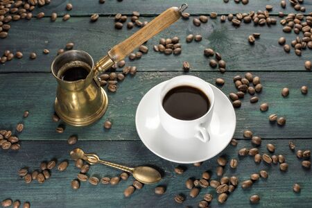 Coffee cup, spoon, and pot with grainsの写真素材