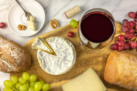Red wine, cheese, bread and grapes at tastingの写真素材