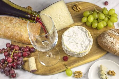 Red wine, cheese, bread and grapes at tastingの写真素材