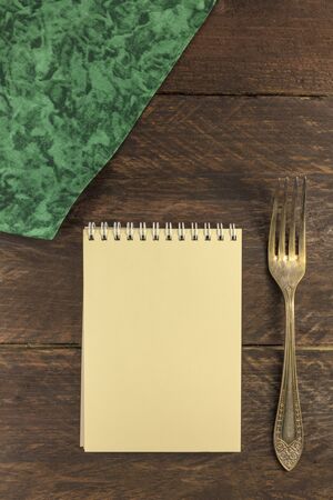 Vintage fork and notepad for copyspace, overhead shotの写真素材
