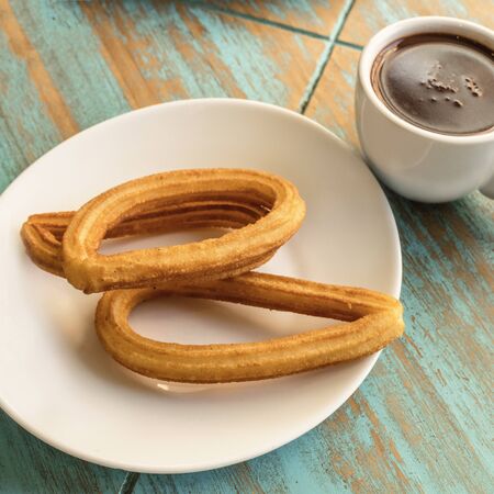 Churros with hot chocolate, traditional Spanish breakfastの写真素材