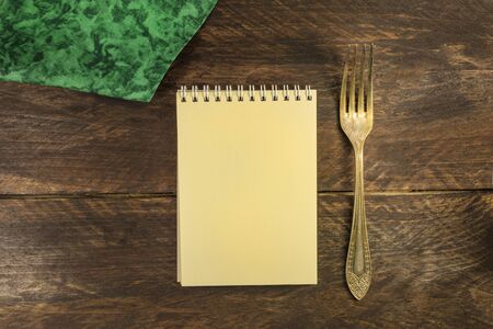 Vintage fork and notepad for copyspace, overhead shotの写真素材