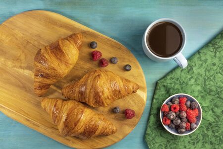 Crunchy French croissants with fresh fruit and chocolateの写真素材