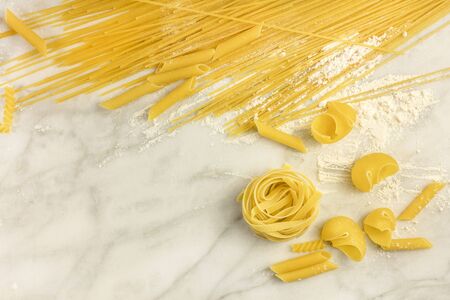 Various types of pasta on marble with copyspaceの写真素材
