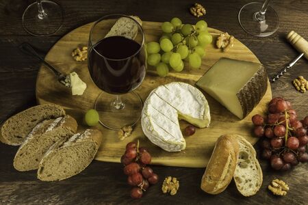 Wine and cheese tasting with bread and grapesの写真素材