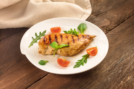 Grilled chicken fillet with cherry tomatoes and salad leavesの写真素材