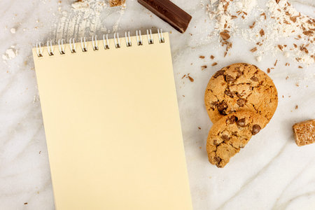 The process of making chocolate chips cookies. Overhead shot of biscuits with chocolate pieces,...