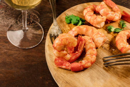 Cooked shrimps with a glass of white wine and copyspaceの写真素材
