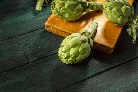 Artichokes on dark rustic textures with copyspaceの写真素材