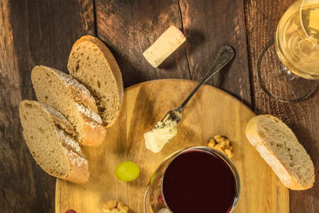 Wine tasting with bread, grapes, and cheeseの写真素材